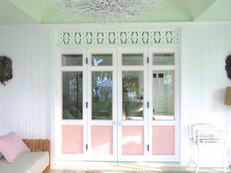 Pink white shutter doors Caribbean beach bungalow