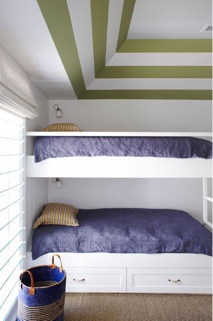 bunk beds in a bedroom with striped ceiling