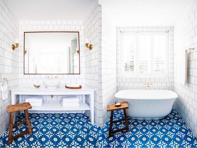 White-bathroom-stand-alone-tub-subway-tile-blue-cement-tile-floor-brass-plumbing-faucet-cococozy-halcyonhouse-blackandspiro
