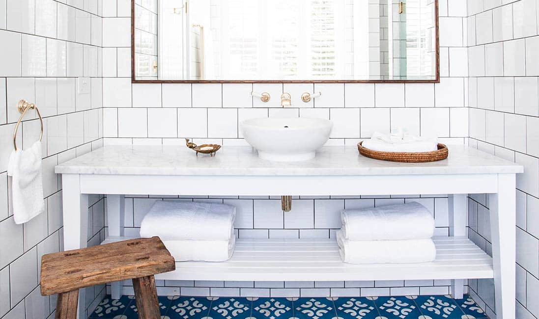 White-bathroom-subway-tile-blue-cement-tile-floor-brass-plumbing-faucet-cococozy-halcyonhouse