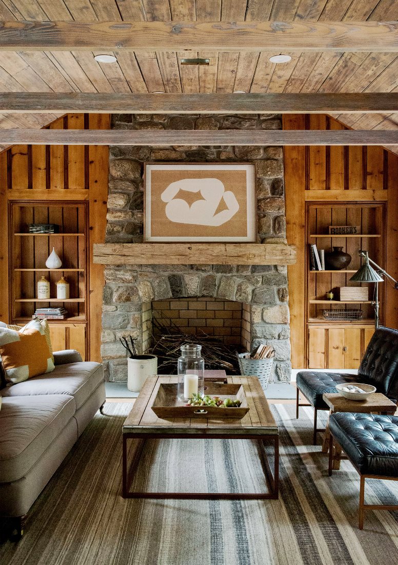 rustic farmhouse restoration living room stone fireplace exposed beam ceiling