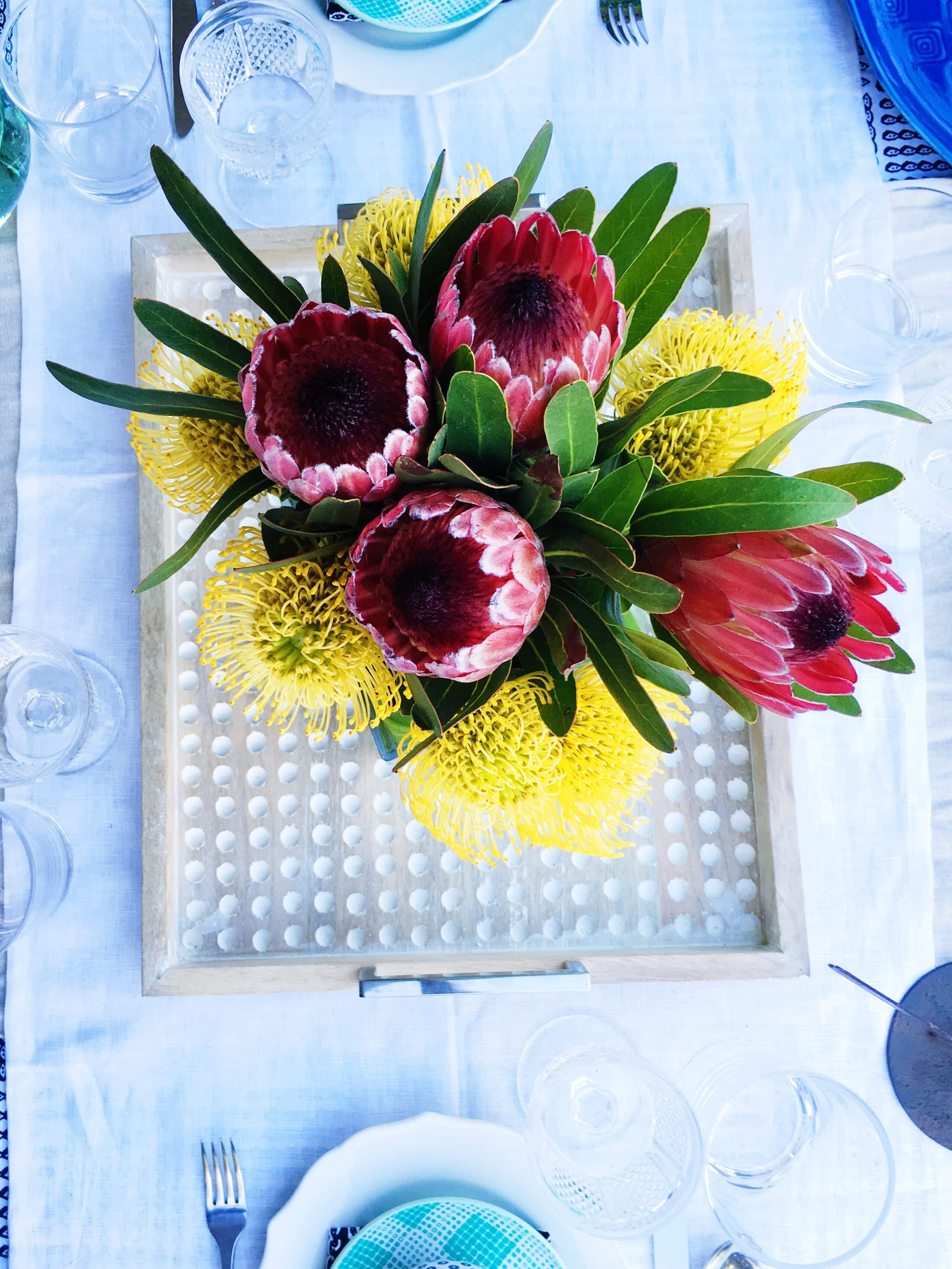 Homemade centerpiece was made from Proteas and yellow Pincushion flowers.