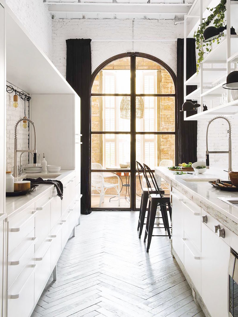 bright barcelona apartment galley kitchen arched windows