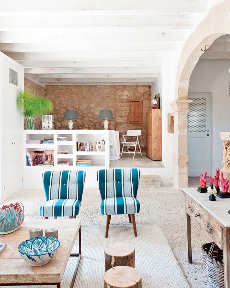 spanish stone villa living room striped chairs