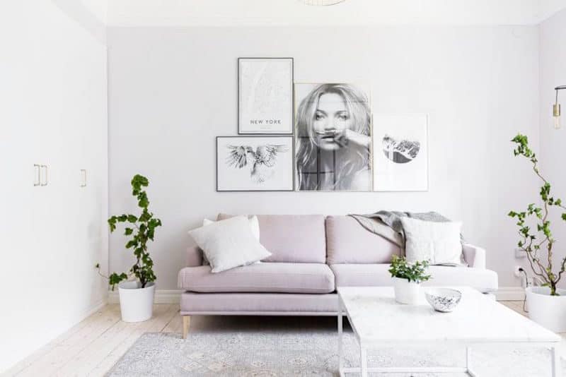 Compact Quarters Living Room Lavender Sofa Grey Rug Wood Floors Gallery Wall