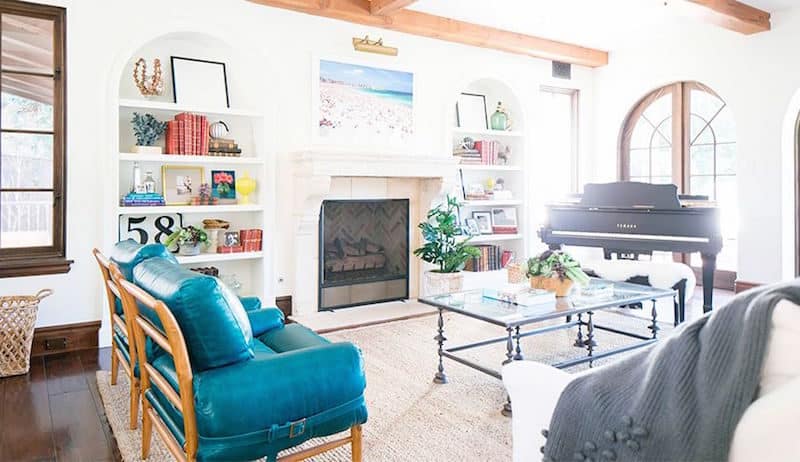 built in bookshelves arched bookshelves grand piano teal chair