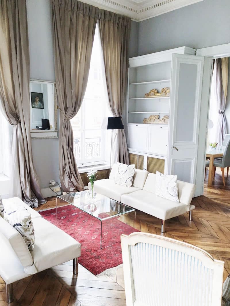 Paris Apartment Living Room White couch herringbone floors