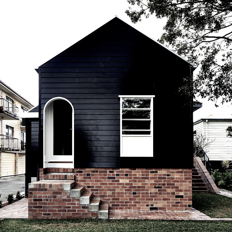 Alt tag for black-white-cottage-exterior-black-brick-white-trim-durhamhouse