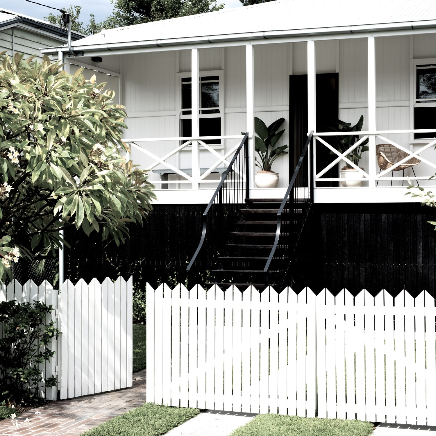 Alt tag for black-white-cottage-exterior-white-picket-fence-cococozy-durhamhouse