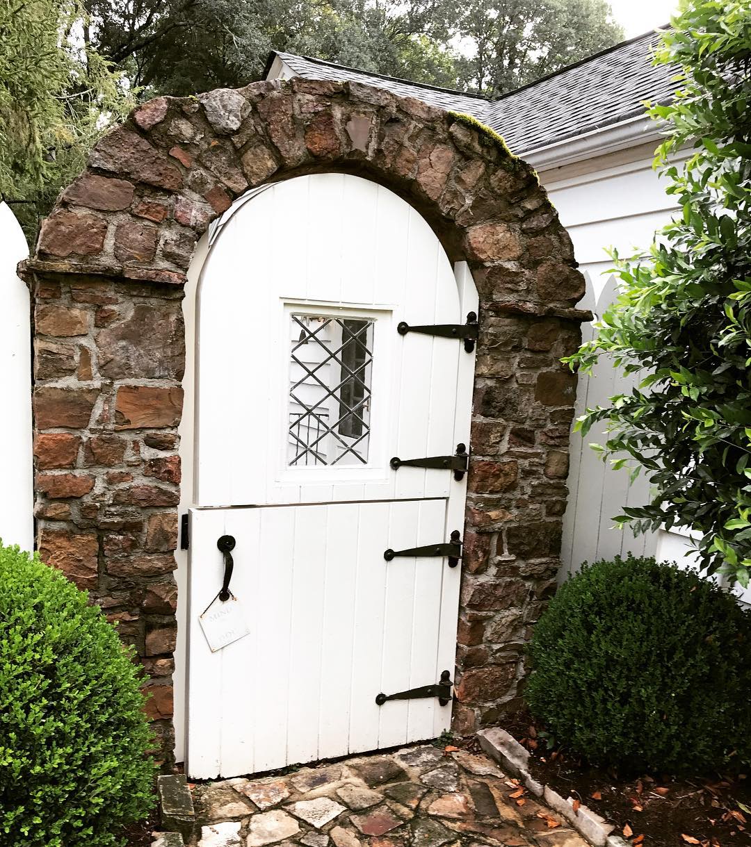 Alt tag for arched-white-dutch-door-garden-gate-brick-cococozy