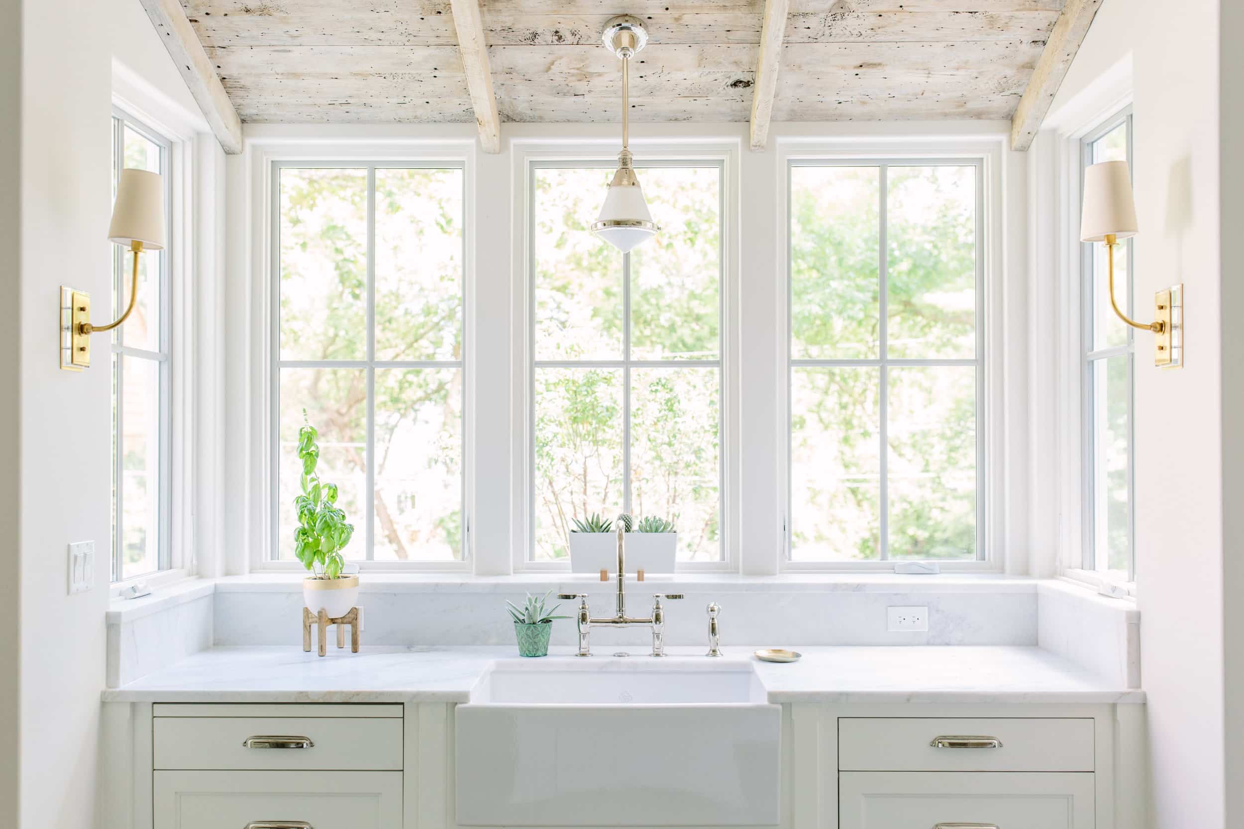 Alt tag for white-modern-open-kitchen-sink-window-light-white-washed-wood-ceiling-cococozy-katemarkerinteriors
