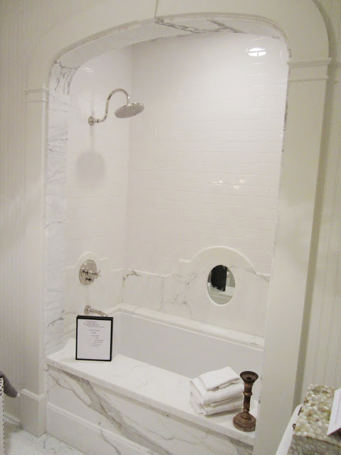  Close up of the arched white carrara marble bath 