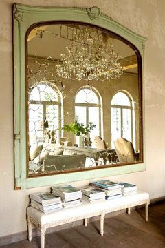 Large antique green mirror with a bench in a mansion in Belgium 