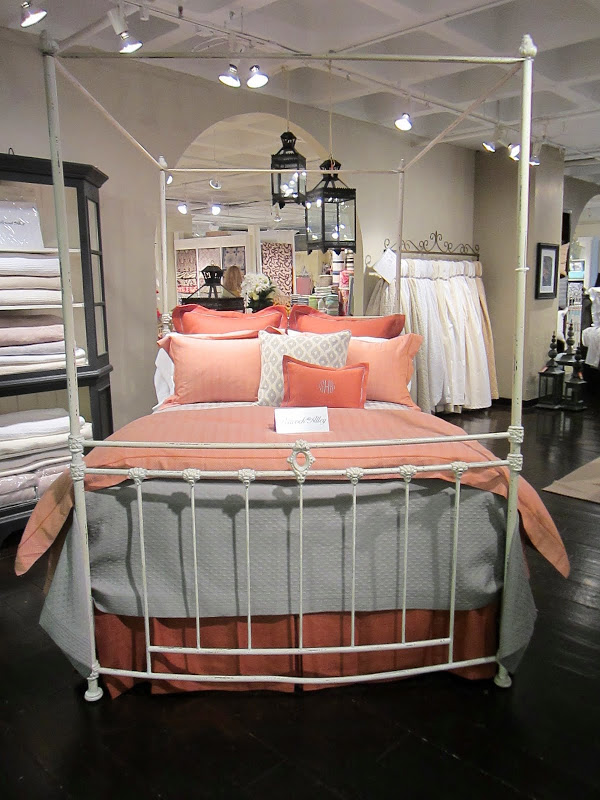 Coral and grey bed from Peacock Alley in a simple, white iron bedframe