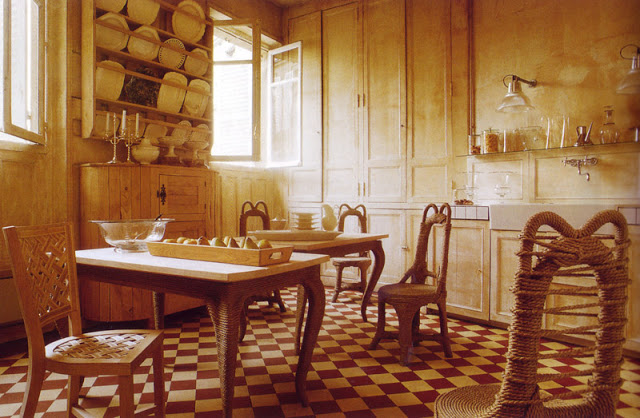 Rustic kitchen with checkerboard tile floor, wood cabinets, a table with rope legs and rope chairs