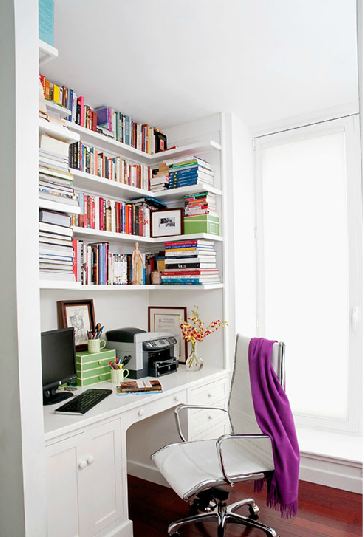 built in desk in a home office with the shelves covered in books