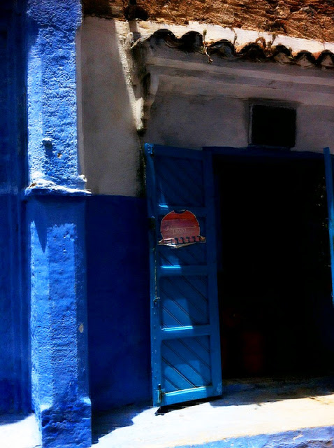 building with the lower half of the wall indigo blue, the upper half cream with blue doors in Morocco