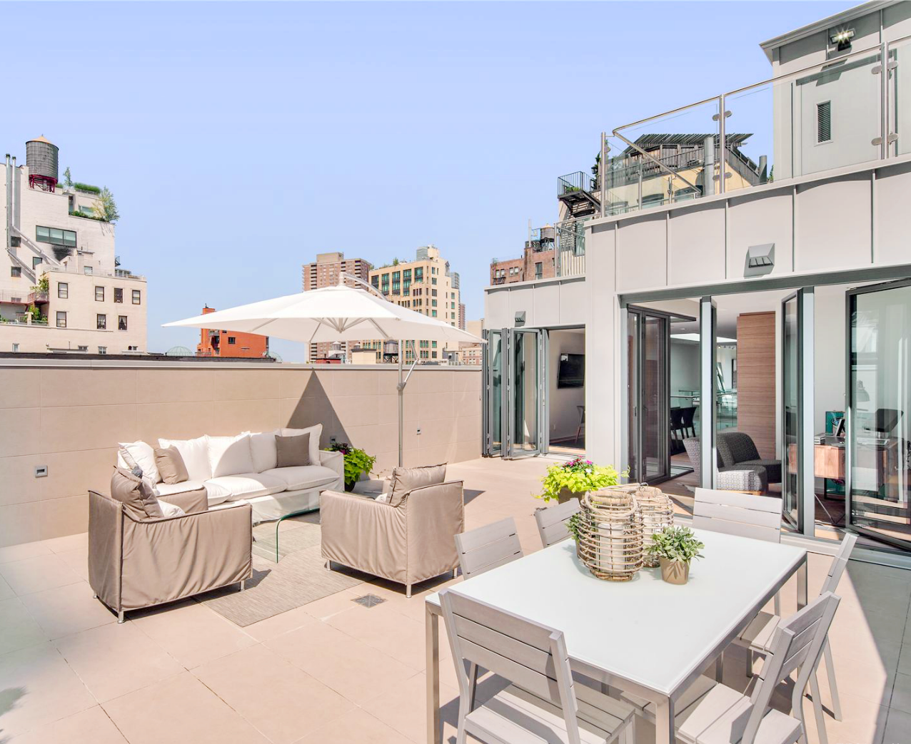 Outdoor dining area and lounge in a NYC penthouse