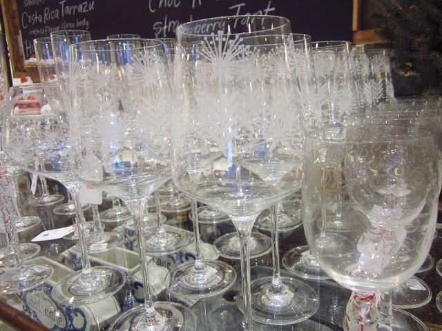 Rows of etched stemwear glass on a glass table 
