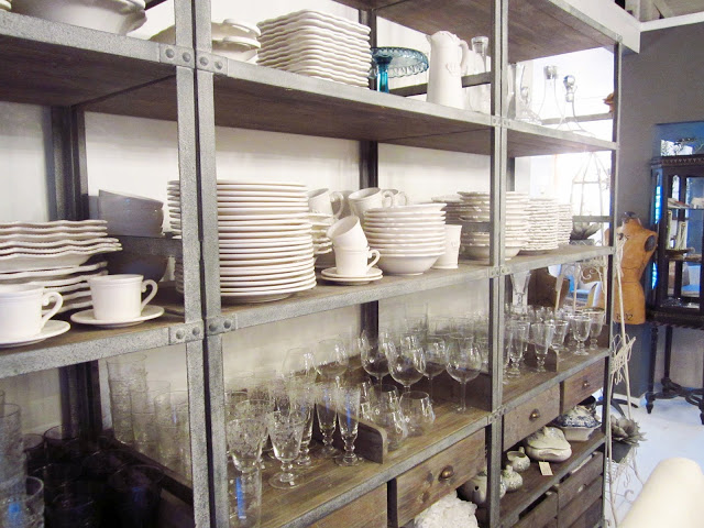 metal display shelf with white dish ware and glassware