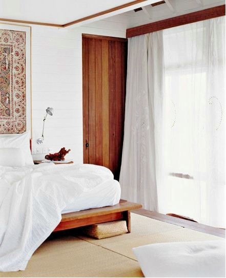 Airy bedroom with atching wood on the platform bed, door, valance and molding on the ceiling