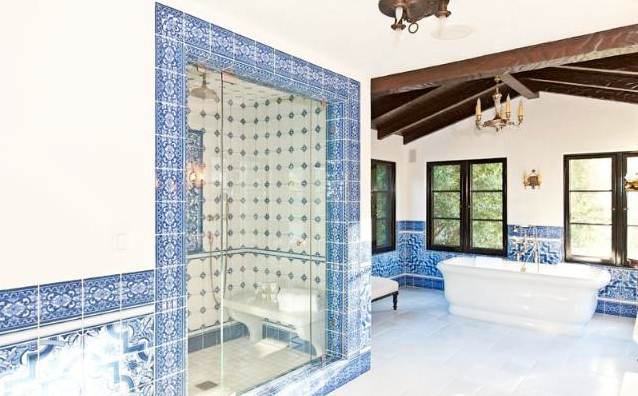 shower with blue and white tiles and bench