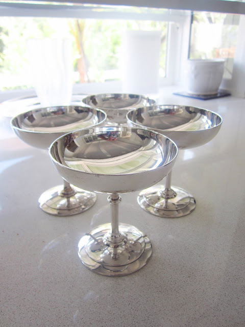 four silver champagne coupes