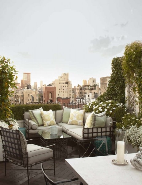 City balcony turned into a living room with a sectional sofa with a wire frame and matching arm chair and coffee table