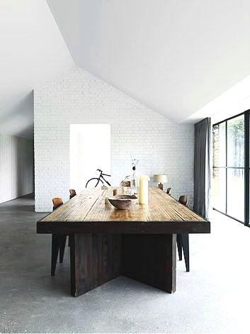 modern dining room wood table white brick wall big glass sliding doors