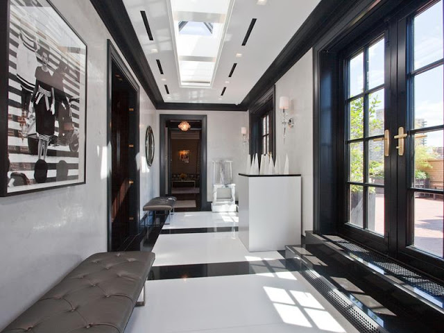 Cococozy Park Avenue Penthouse Apartment real estate listing black and white foyer with a skylight, black and white marble floor, black French doors leading to a patio, and leather benches