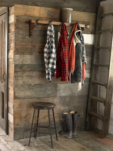 boots in a mudroom foyer with reclaimed wood walls 
