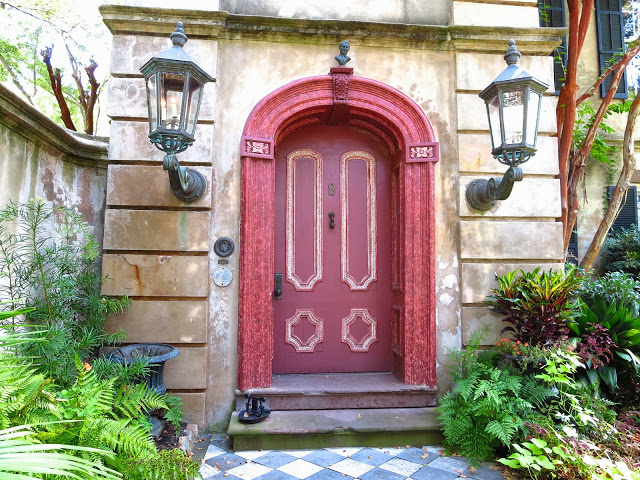Arched red door and checkered marble path in Charleston, South Carolina