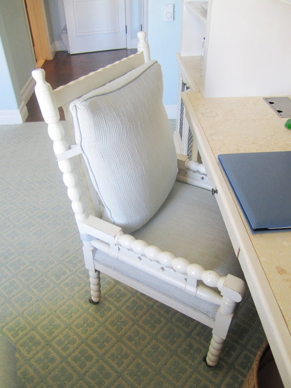 Close up of the painted white, carved desk chair in a Casa del Mar guest room