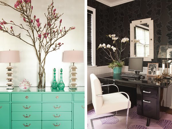 On the left there is a mint green chest of drawers with matching gold lamps with pale pink shades, two green bottles and a vase holding Japanese Magnolia branches. On the right is a home office with a purple rug, white chair, black laquer desk with a white orchid in a turquoise pot. The walls are covered in dark wall paper until you reach the bottom half it is white paneling. Behind the desk is a mirror in a white frame. 
