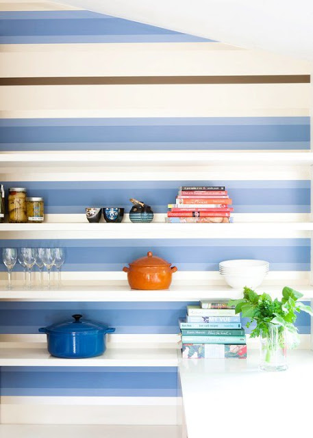 close up of kitchen with blue and white stripped backsplash with white floating shelves