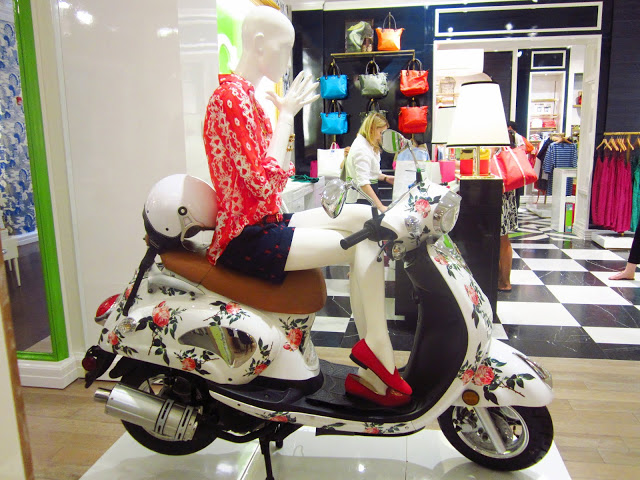 mannequin sitting on a floral scooter