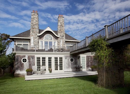 exterior of Hamptons mansion with patio and lawn