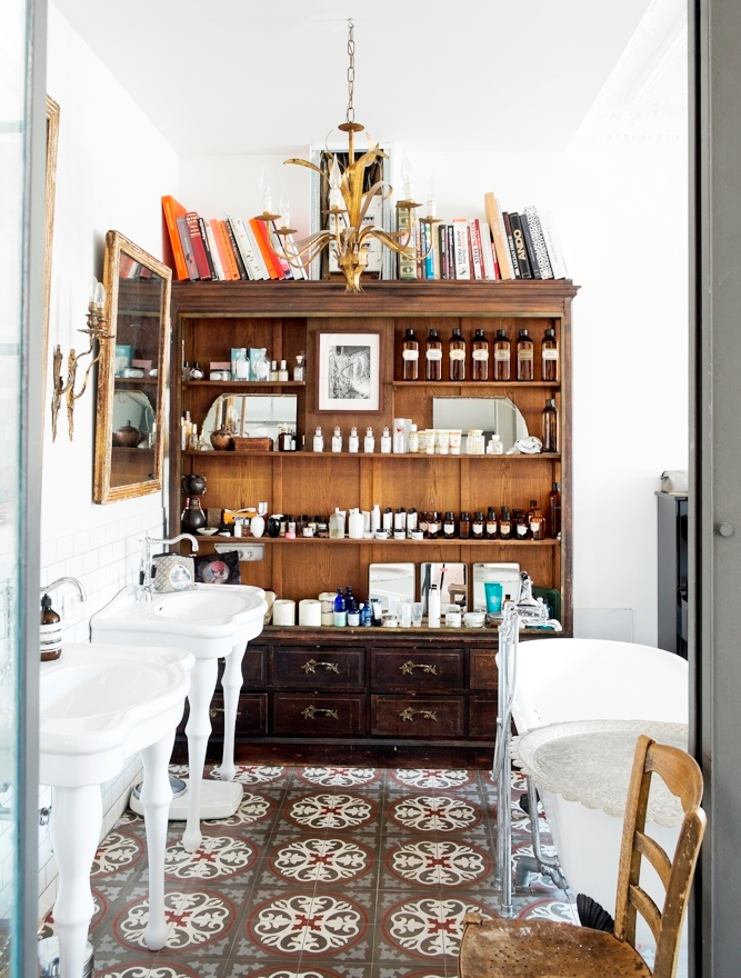 Eclectic bathroom with antique cupboards and cement tile floor