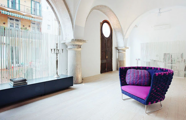 purple and magenta accent chair in a Barcelona cloister turned home