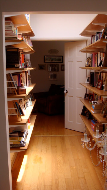 Before: Hall library made with with honey colored open shelving bookshelves