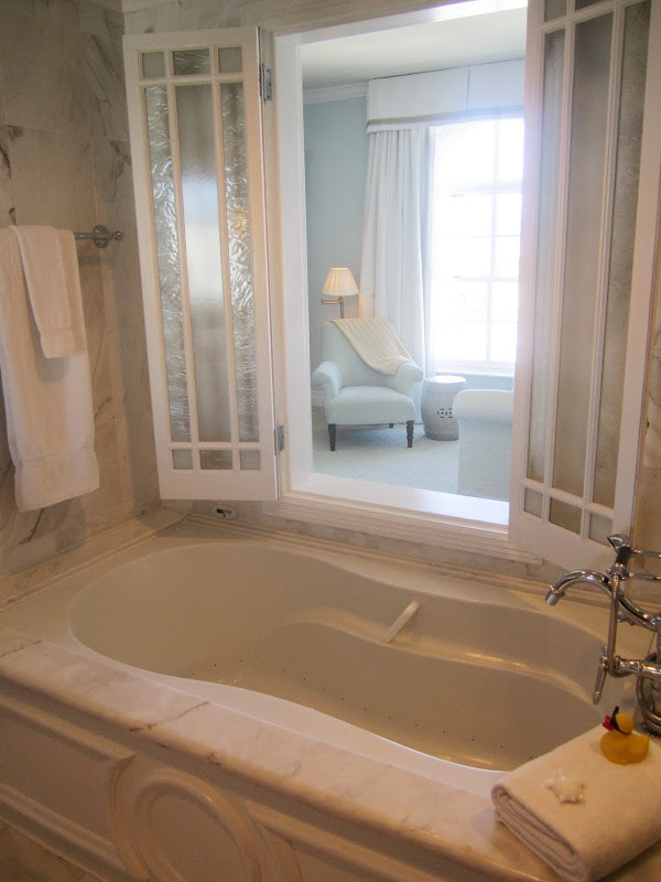 Close up of the marble tub and window into the bedroom in a Casa del Mar guest room