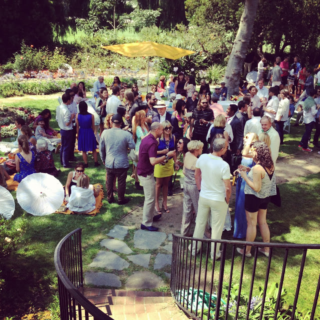 people mingling at a garden party for LAXART