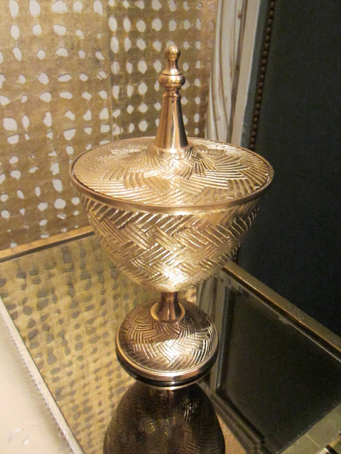 gold container on a glass nesting table in the Windsor house