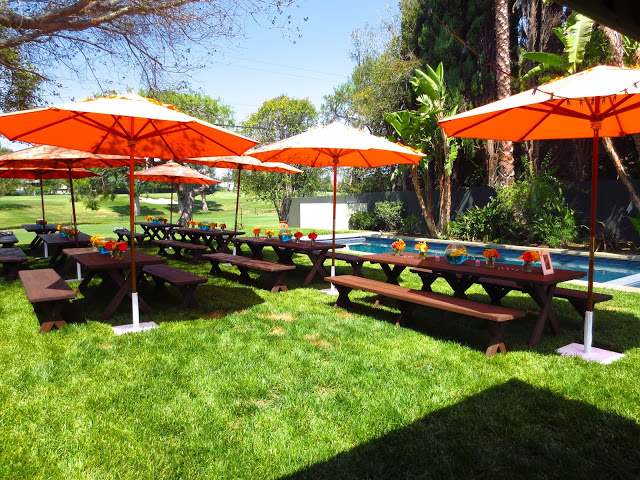 Outdoor backyard baby shower orange umbrellas pool creative centerpieces 