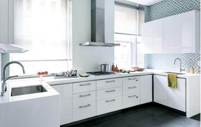 small white kitchen light blue wallpaper geometric pattern stainless hood integrated cooktop cook bright