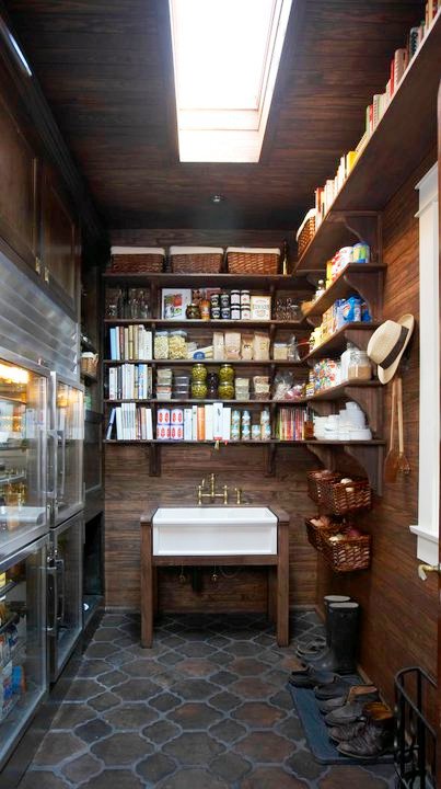 Pantry with Saltillo tile floors, wood paneled walls, open shelving, and a farm house sink