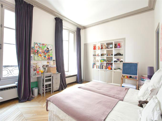 Bedroom with purple curtains and herringbone wood floor