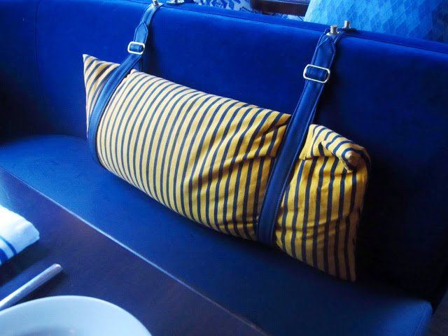 close up of yellow striped pillows attached with  buckles