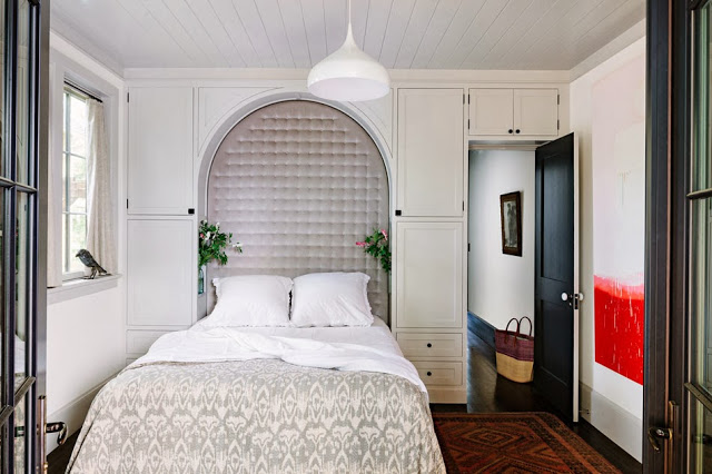 Bedroom with built in tufted arch headboard