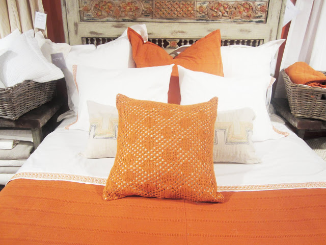 Close up of the orange and white Coyuchi pillows